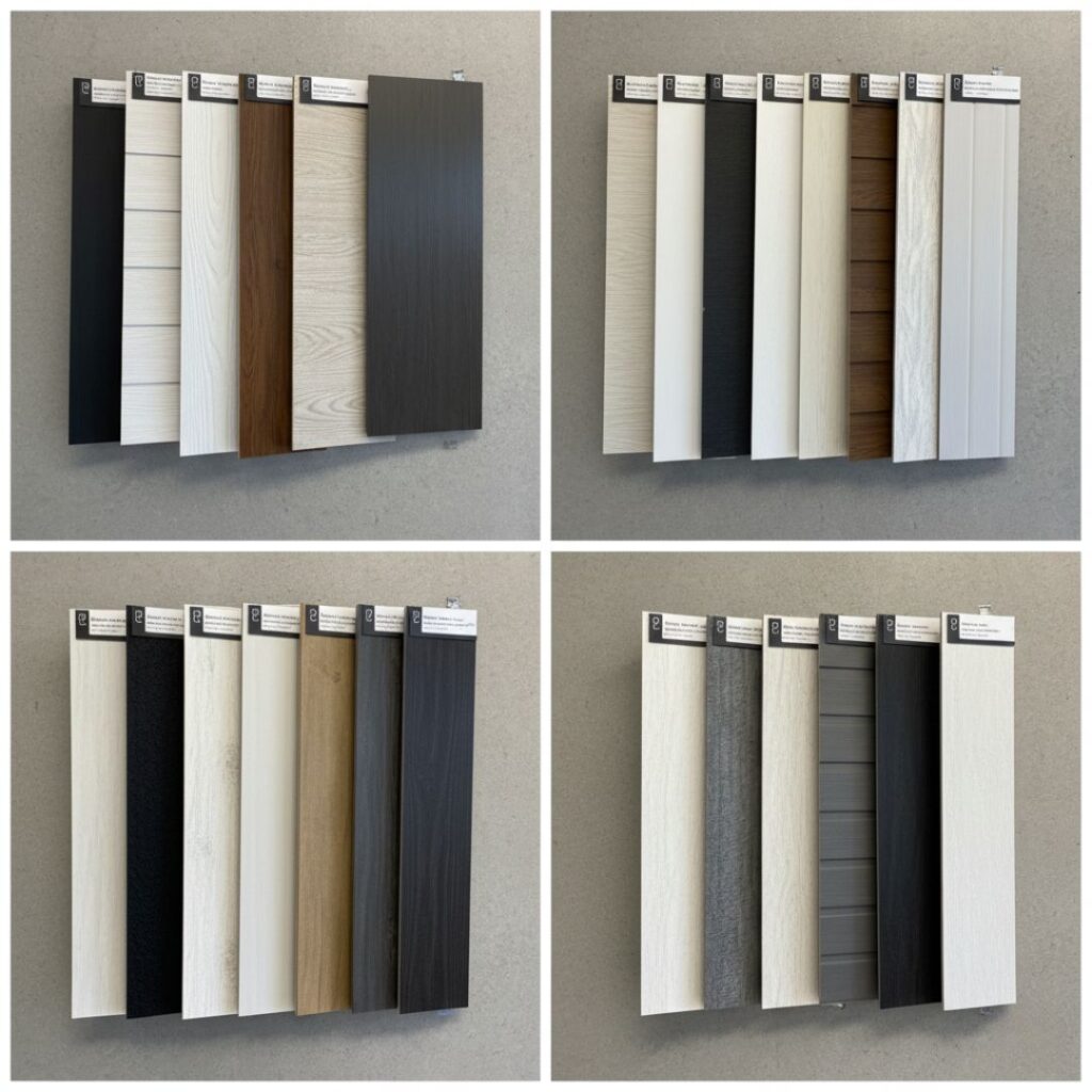 Multiple siding material samples in various colors and textures are neatly arranged against a wall.